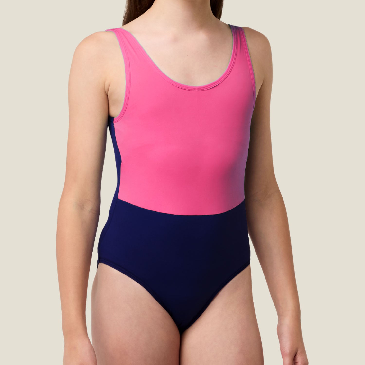 Close-up of front view of WUKA Teen Racerback Period Swimsuit in two-tone pink and purple, showing seam detail and smooth fit.