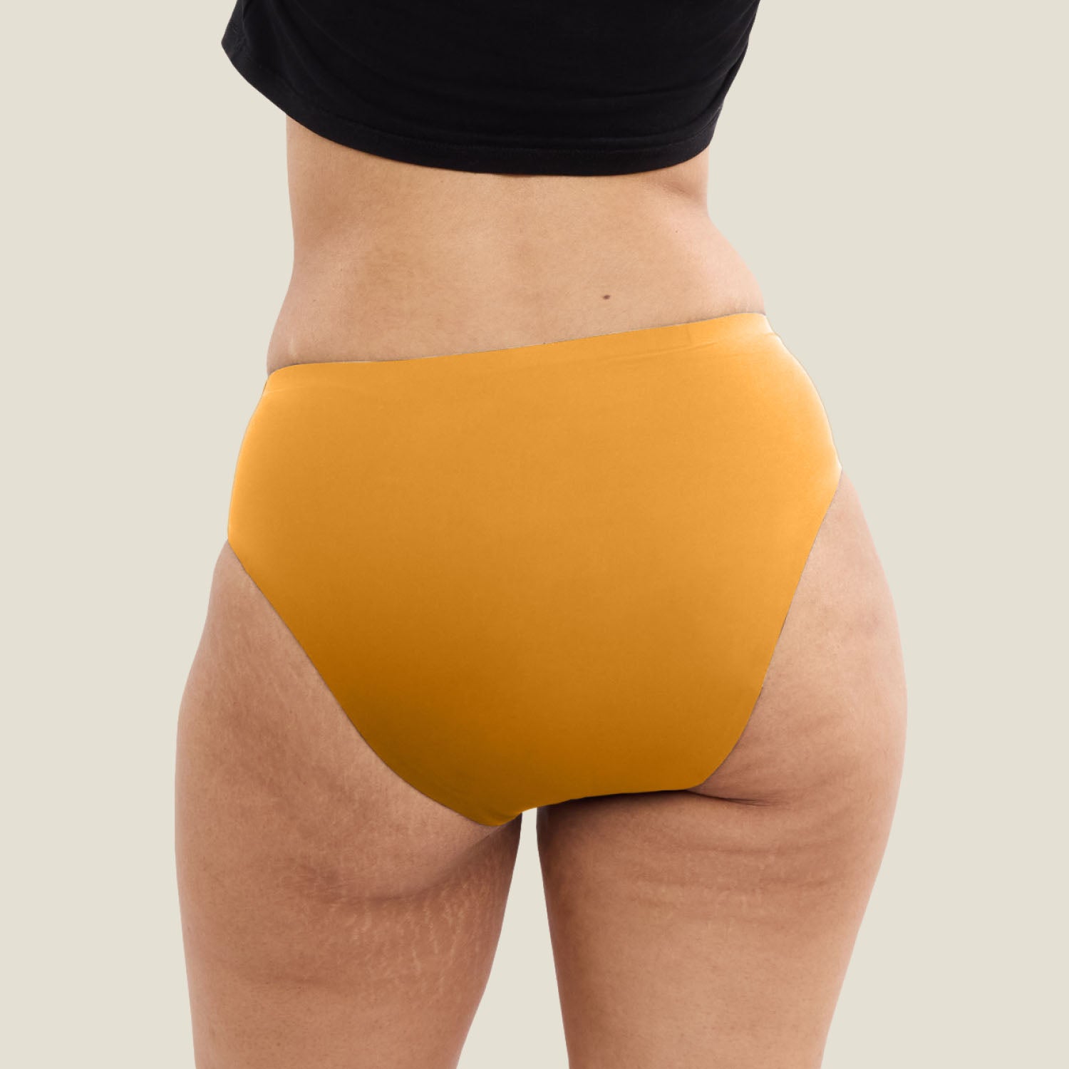 Back view of limited edition WUKA Teen Stretch Seamless Midi Brief in orange. Heavy flow period underwear offering full coverage and secure fit.