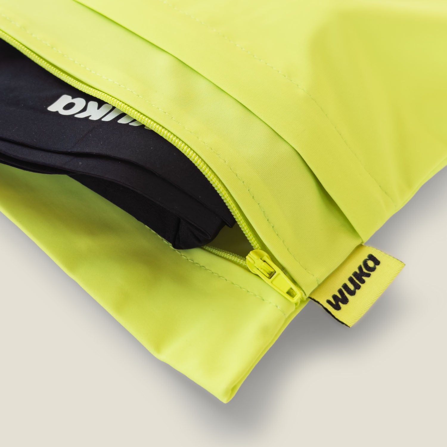 Close-up of the zip and stitching on WUKA’s lime punch changing bag, showcasing durable, water-resistant design for secure period product storage