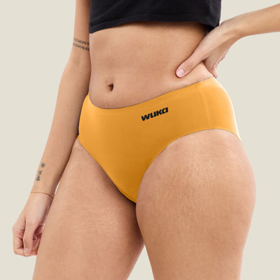 Side profile of orange WUKA Teen Stretch Seamless Midi Brief. Limited edition heavy flow period pants with sleek fit and seamless comfort for teens.