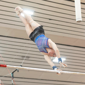 Gymnast performing on apparatus while wearing WUKA period-proof sports underwear, reflecting partner testimonials on support for periods in gymnastics